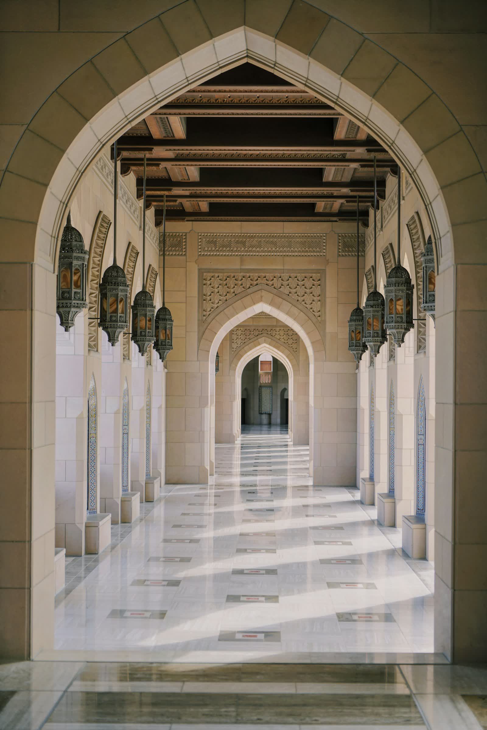 A long corridor of pointed arches and pale stone columns